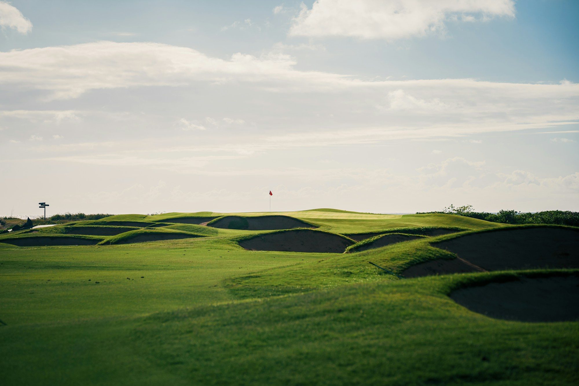 Rolling golf course with sand bunkers