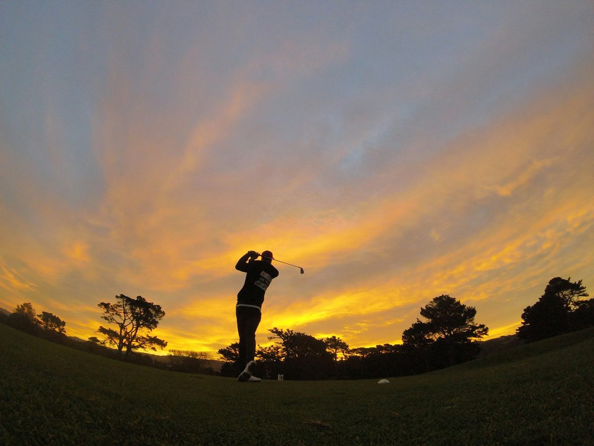 Golfer silhouetted at dusk